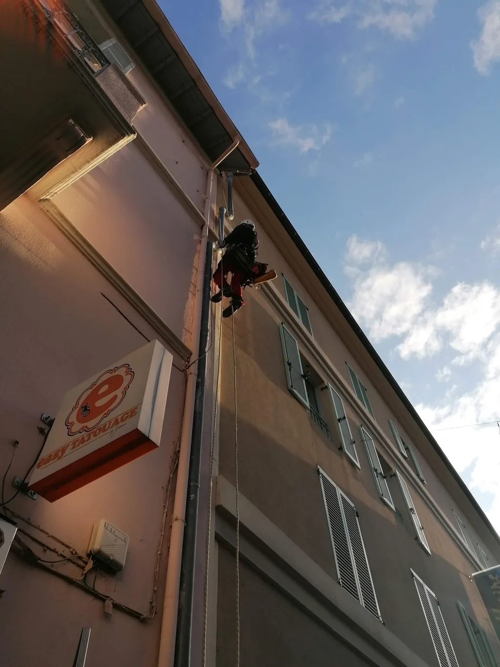 Rope access technician on an apartment building facade