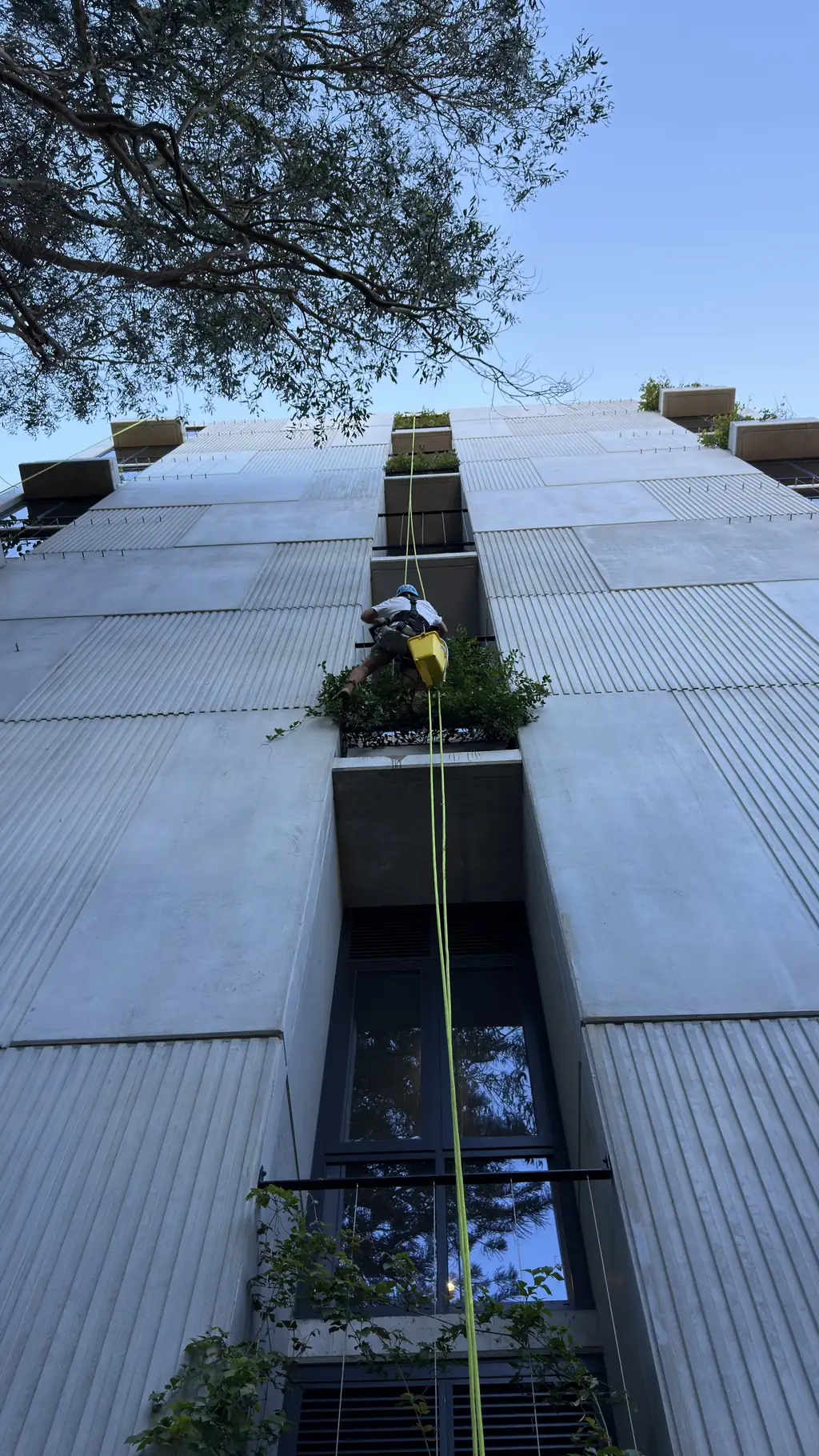 Rope access technician on an apartment building facade