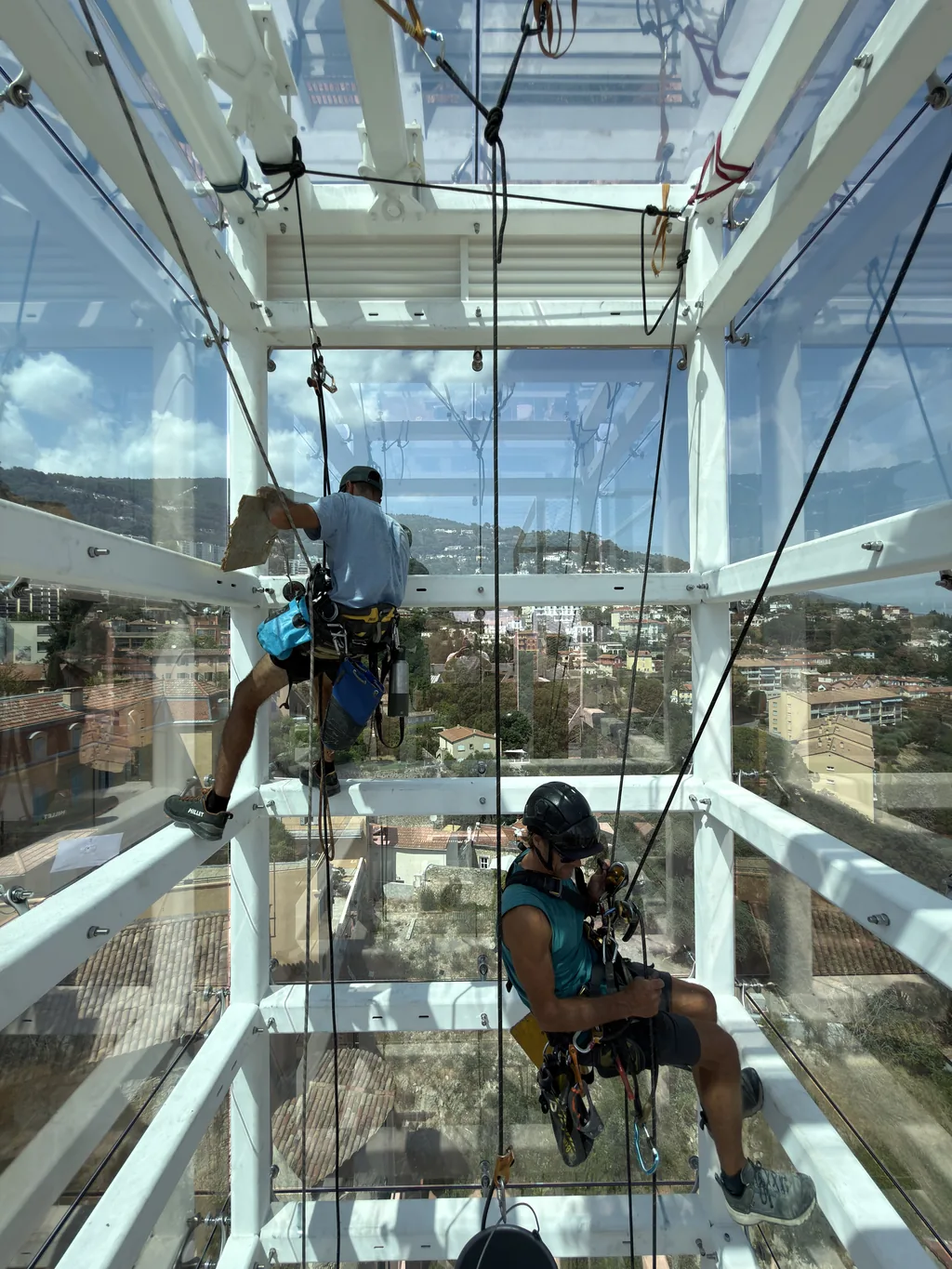 Rope access technicians inside a glazed structure