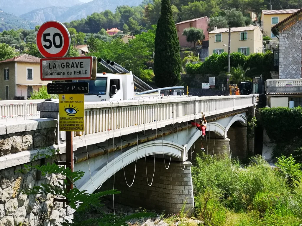 Rope access work under a bridge, La Grave (Peille)