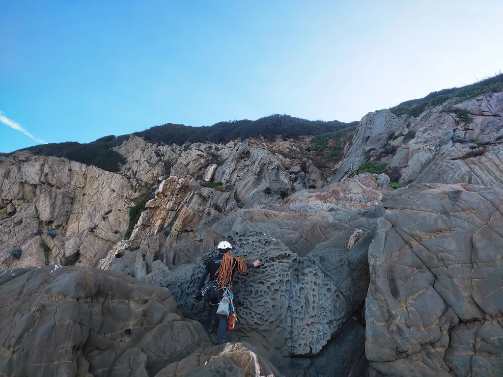 Rope access technician inspecting the rocks