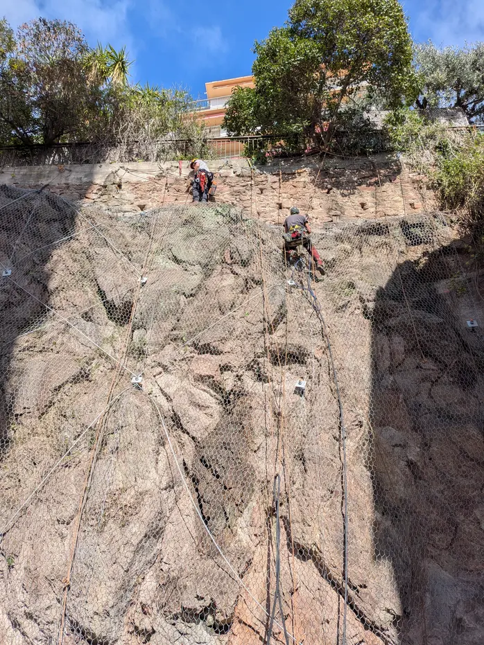 Rope access technicians on a rock face