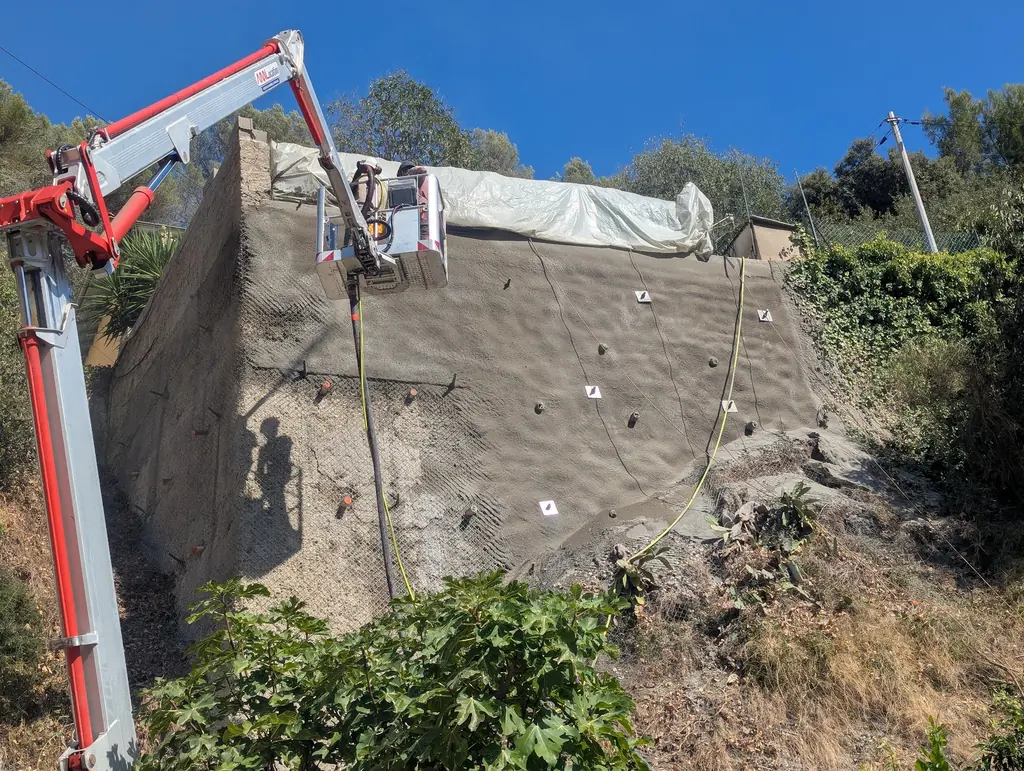 Reinforcing a wall with shotcrete from an aerial work platform