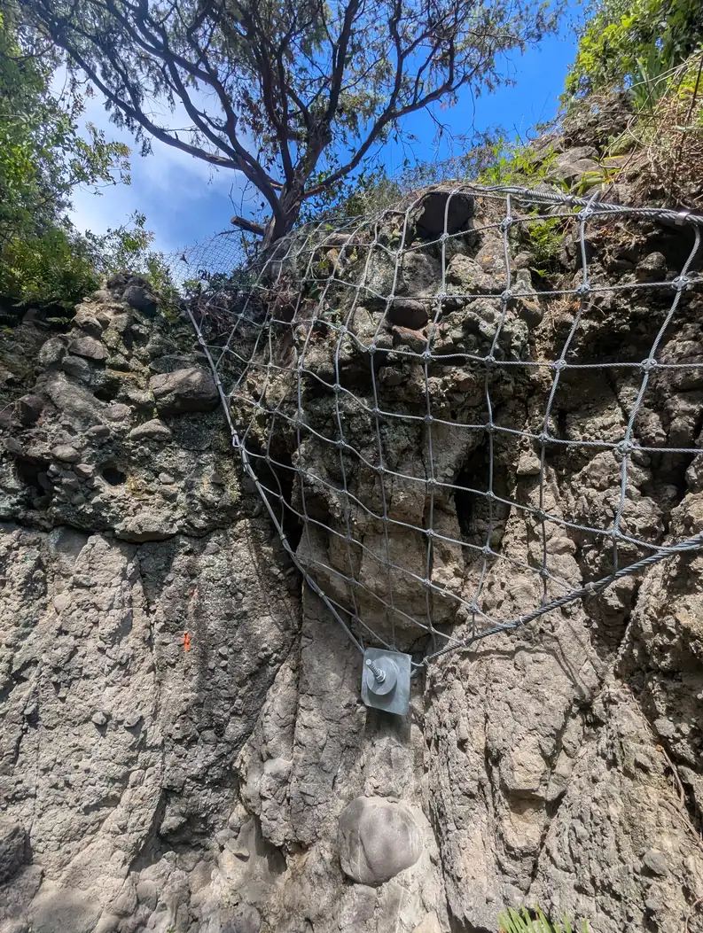 Rock face with net and anchor