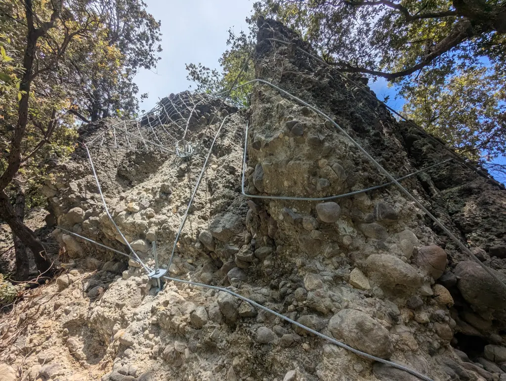 Rock face held by nets and cables