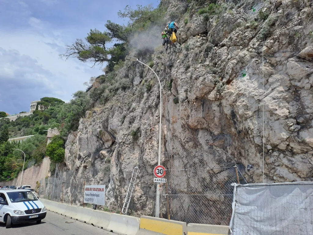 Rock face stabilisation works above a road