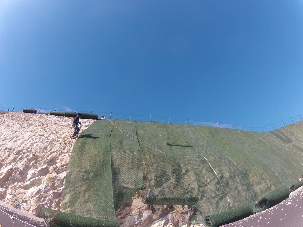 Protective mesh on an embankment