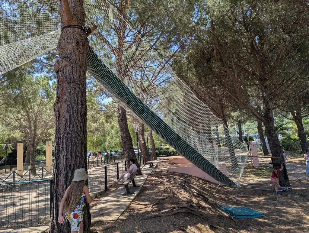 Net walkways stretched between the trees of a park