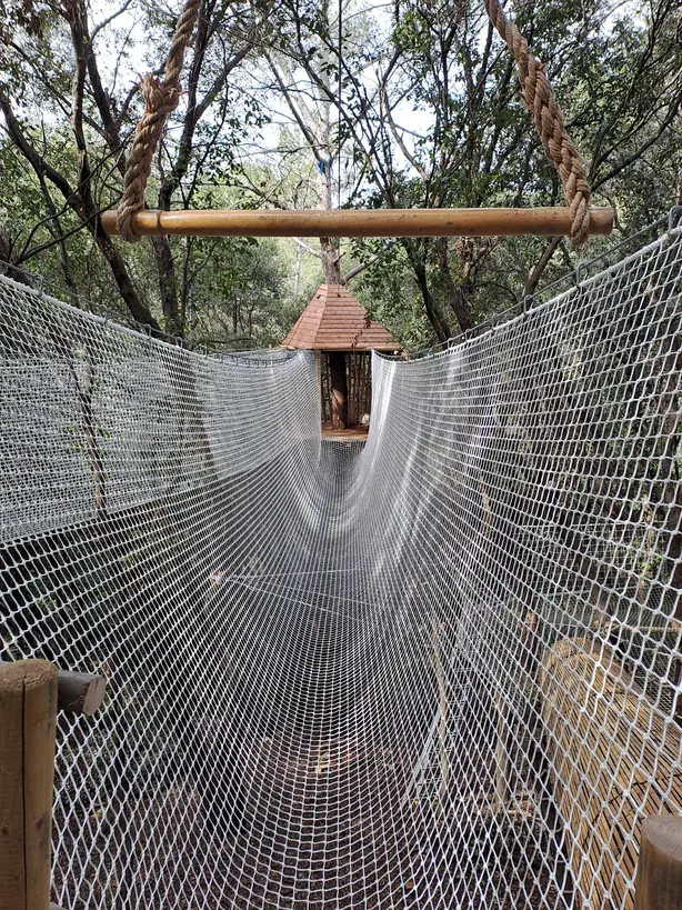 Net walkway leading to a treehouse