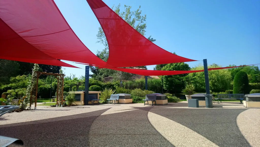 Red shade sails stretched over a terrace